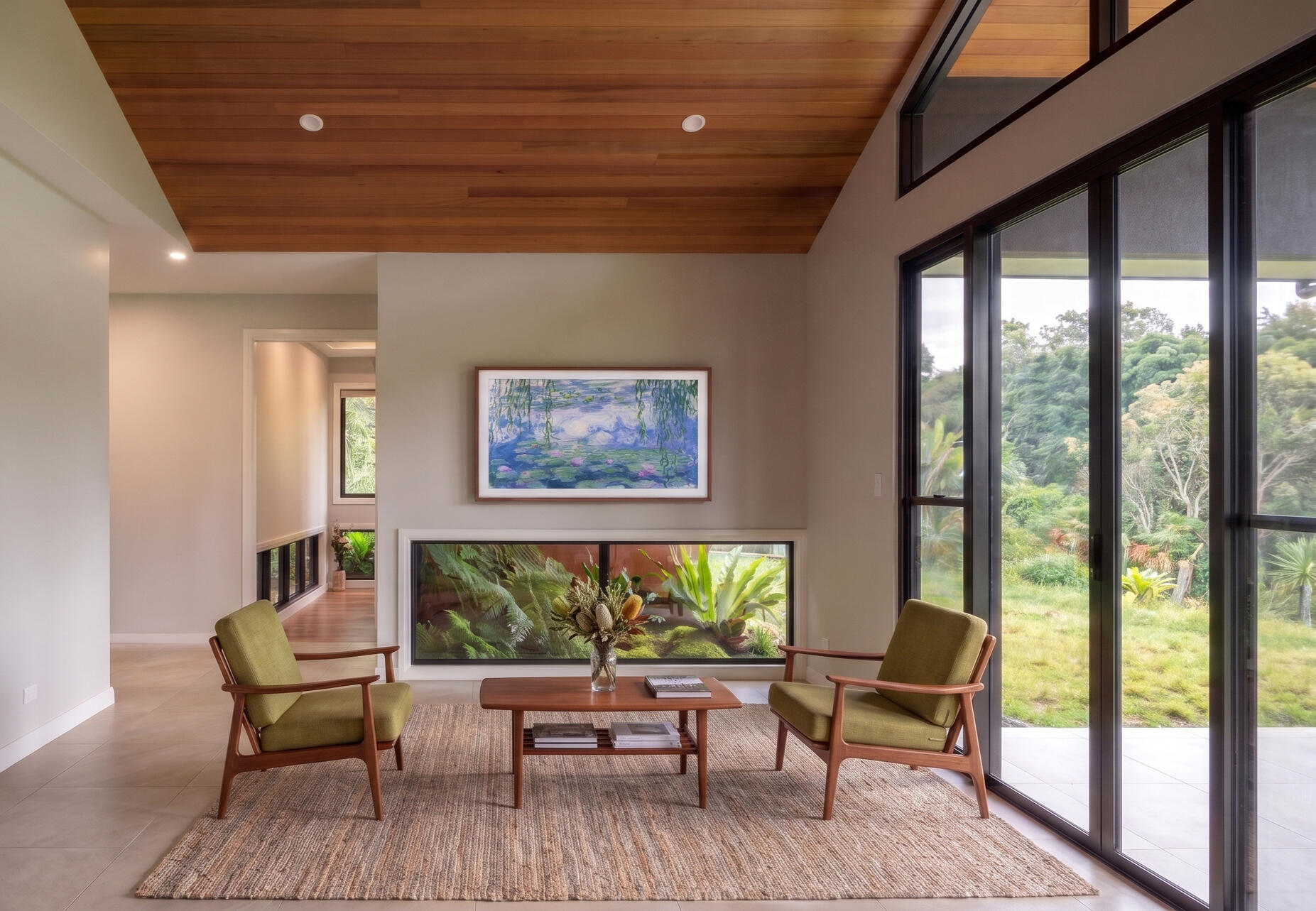 Living space light, low garden views and distant outlook Studio Violett Mt Tamborine project interior living space highlighting natural light, subtle shadows, curated furniture, and framed distant views