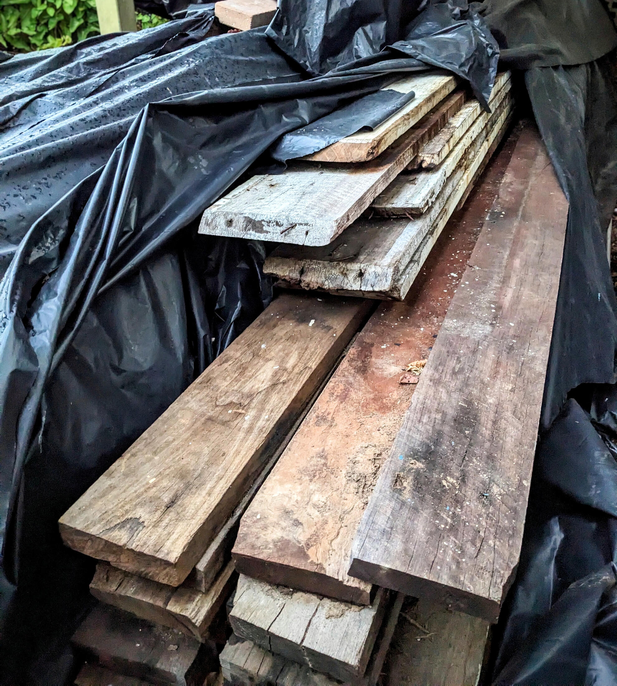 Recycled timber awaiting reuse Studio Violett Oxley Farmhouse recycled timber awaiting reuse as cladding and structural elements highlighting sustainable craftsmanship